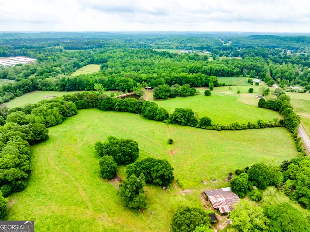 an aerial view of a houses with a yard