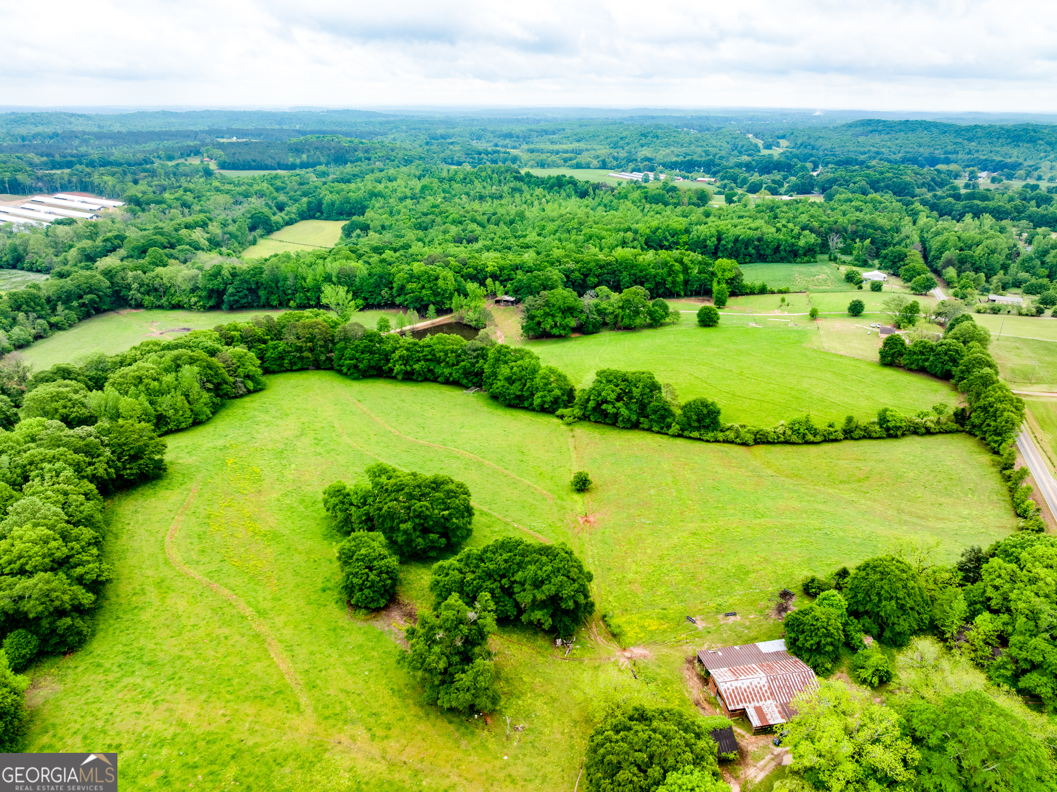 an aerial view of a houses with a yard