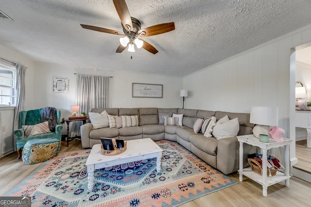 a living room with furniture and a rug