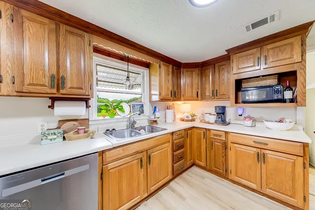 a kitchen with a sink cabinets and window