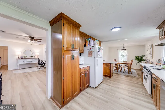 a kitchen with stainless steel appliances granite countertop a stove a sink and cabinets