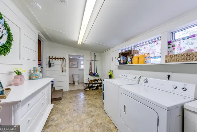 a bathroom with a granite countertop sink mirror and toilet