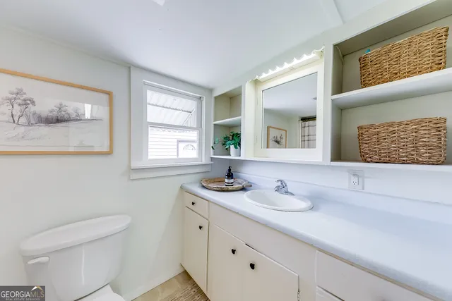 a bathroom with a toilet and a shower curtain