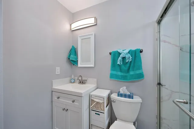 a bathroom with a toilet sink and mirror