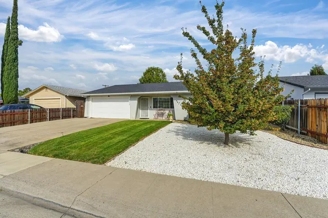a front view of a house with garden