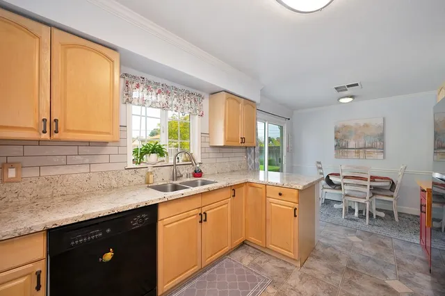 a kitchen with a sink stove and cabinets