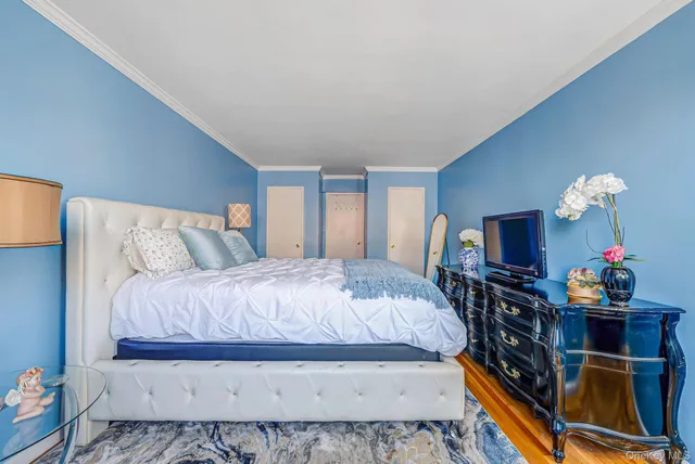 a bedroom with a bed and a flat screen tv