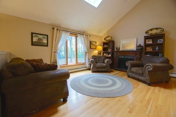 53 Baldpate Road Georgetown, MA 01833 - Photo 8 of 30 a living room with furniture and a fireplace