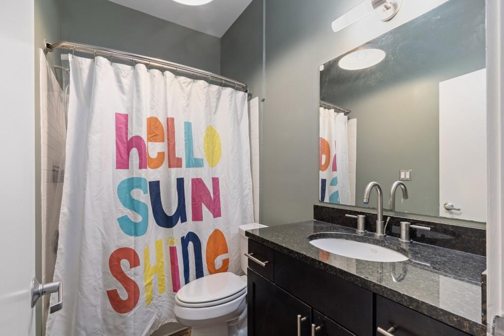 659 Auburn Avenue Northeast, Unit 120 Atlanta, GA 30312 - Photo 13 of 22 a bathroom with a sink a toilet and shower curtain