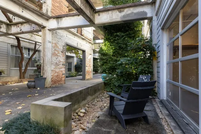a view of a house with backyard and sitting area