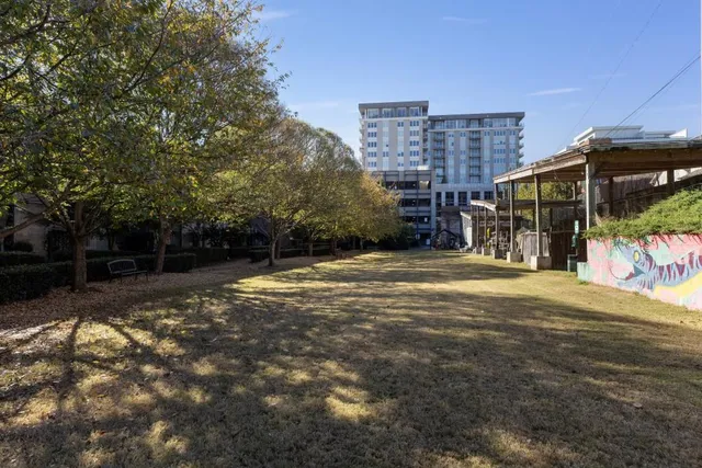 a view of a house with backyard and trees
