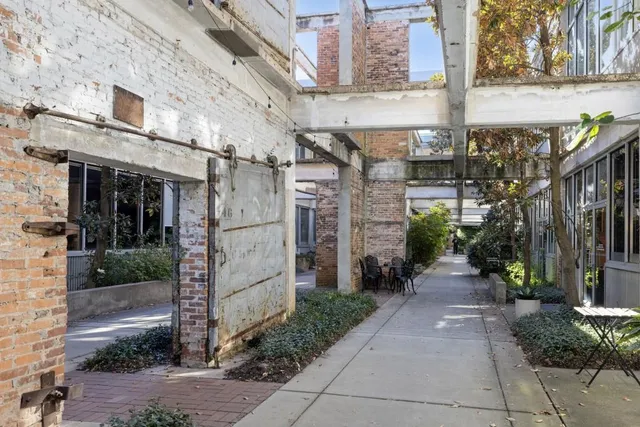 a view of a brick building next to a yard