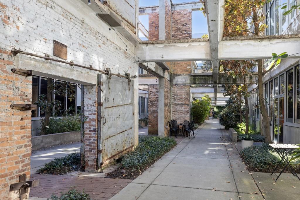 659 Auburn Avenue Northeast, Unit 120 Atlanta, GA 30312 - Photo 4 of 22 a view of a brick building next to a yard