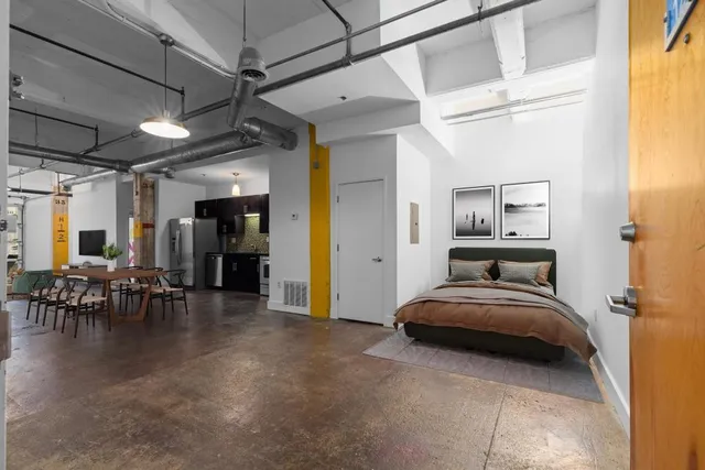 a bedroom with a bed and a table