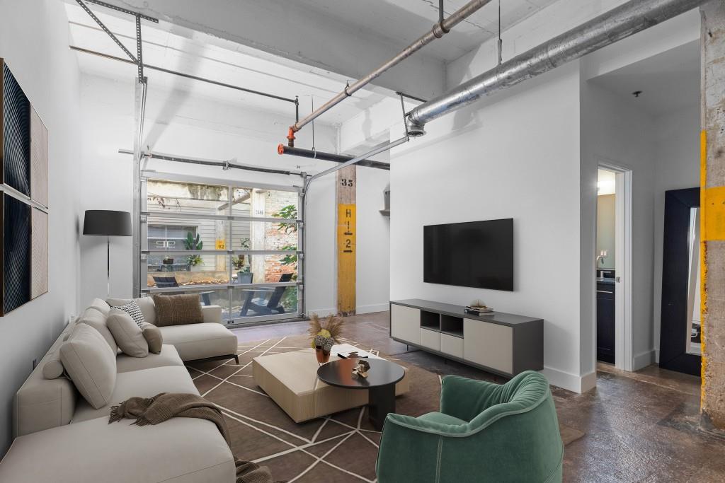 659 Auburn Avenue Northeast, Unit 120 Atlanta, GA 30312 - Photo 10 of 22 a living room with furniture and a flat screen tv