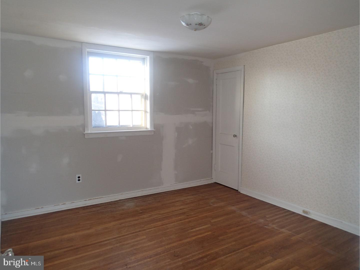 249 Fairview Road Springfield, PA 19064 - Photo 11 of 16 wooden floor in an empty room with a window