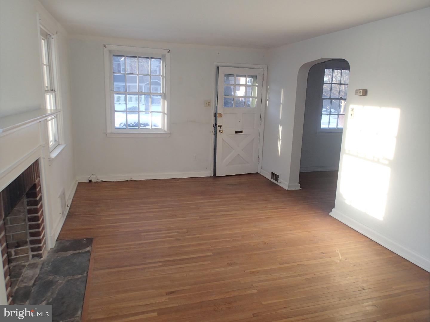 249 Fairview Road Springfield, PA 19064 - Photo 3 of 16 a view of an empty room with window and wooden floor