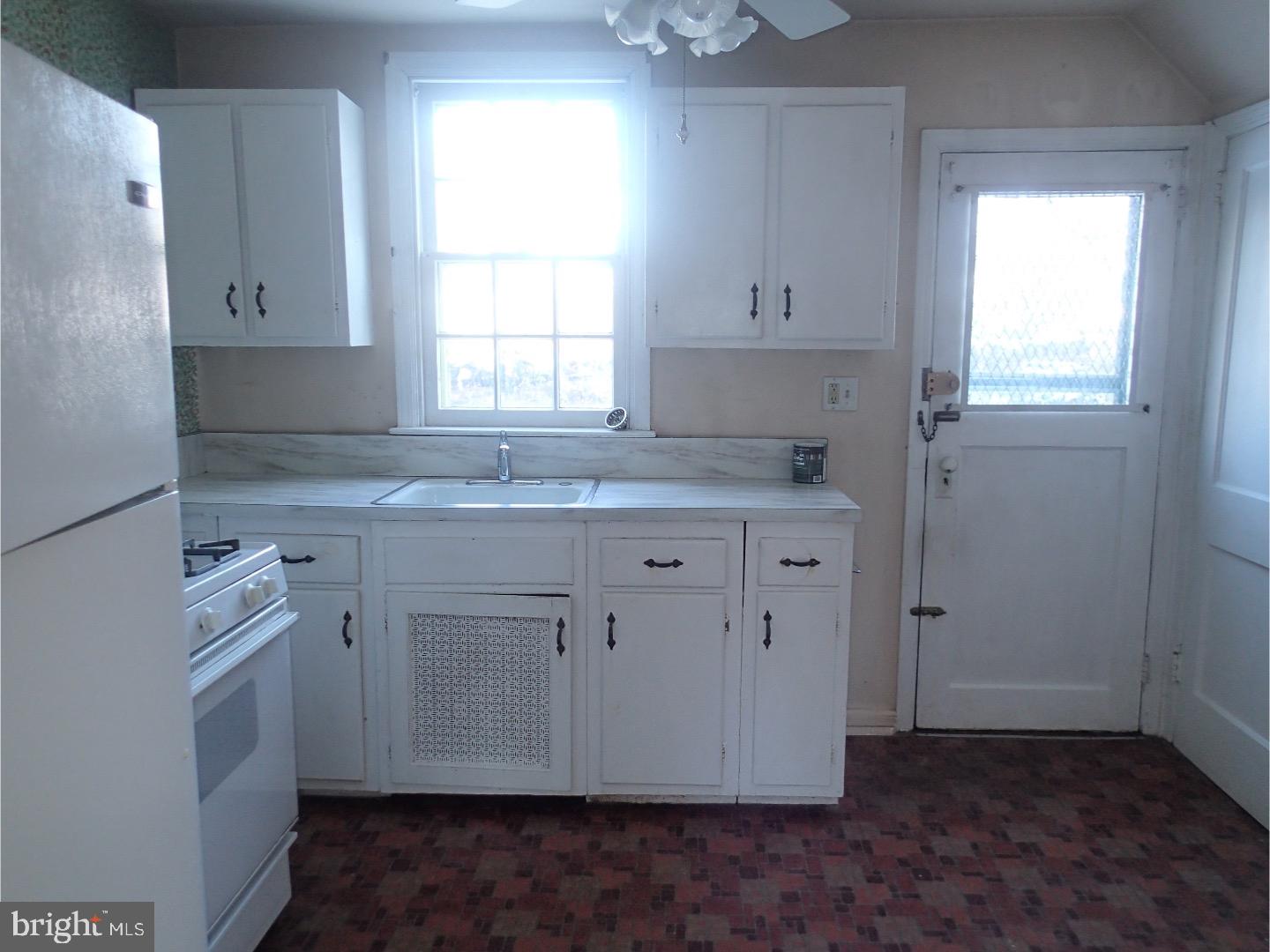 249 Fairview Road Springfield, PA 19064 - Photo 6 of 16 a view of cabinets a sink with wooden floor