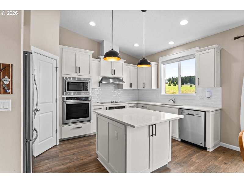 25850 Foster Road Monroe, OR 97456 - Photo 21 of 48 a kitchen with stainless steel appliances granite countertop a sink a stove a refrigerator and a refrigerator