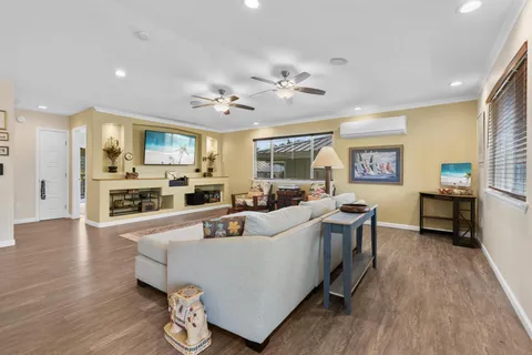 a living room with furniture and a wooden floor
