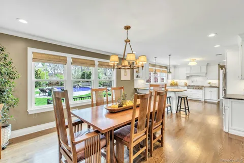 a dining room with furniture window and wooden floor
