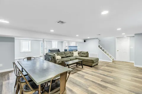 a living room with lots of furniture and a wooden floor