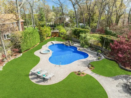 a view of a backyard with table and chairs & fire pit