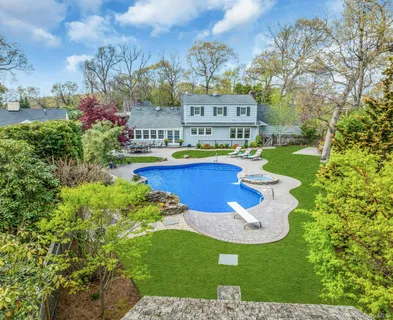 a view of a swimming pool with a yard