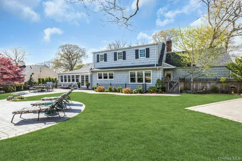 a view of a house with a yard table and chairs