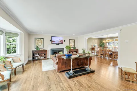 a living room with furniture large window and a table