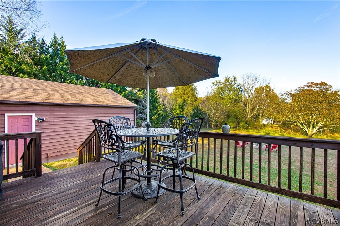 2104 Broad St Road Maidens, VA 23102 - Photo 24 of 29 a view of a table and chairs under an umbrella