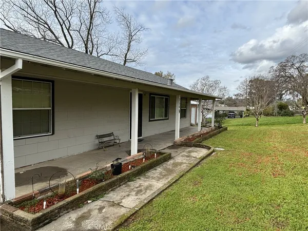 a backyard of a house with barbeque oven
