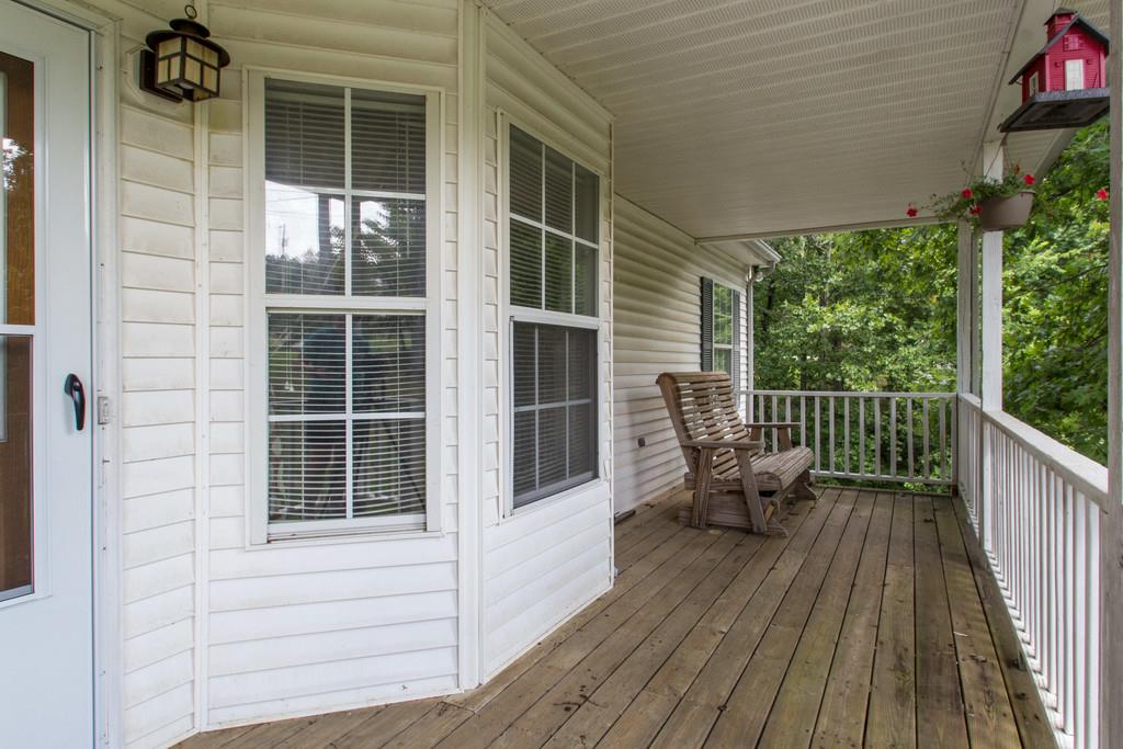 201 Gaskins Road Dickson, TN 37055 - Photo 2 of 24 a view of a balcony with chairs and wooden floor