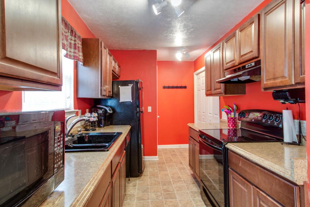 201 Gaskins Road Dickson, TN 37055 - Photo 8 of 24 a kitchen with stainless steel appliances granite countertop a stove a sink and a refrigerator