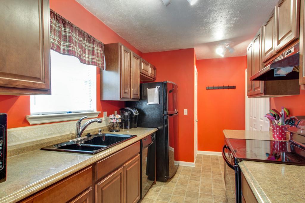 201 Gaskins Road Dickson, TN 37055 - Photo 9 of 24 a kitchen with stainless steel appliances a sink stove and cabinets
