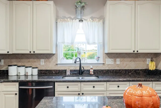 a dining room with furniture window wooden floor and a chandelier