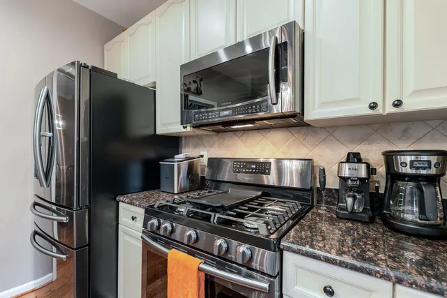 a living room with furniture a large window and a fireplace