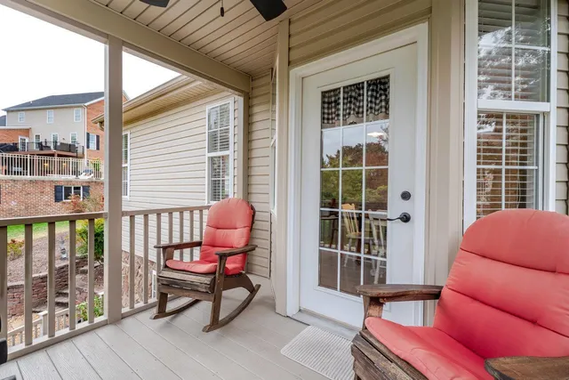 a living room with furniture and a view of kitchen