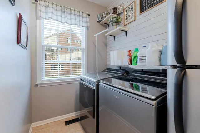 a bedroom with a bed a dresser and flat screen tv