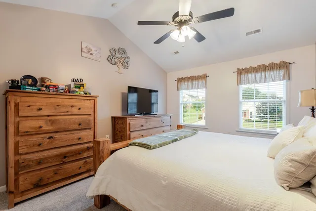 a bedroom that has a bed and a table in it