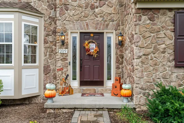 a front view of a house with a yard and sitting area