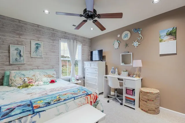 a bedroom with a bed couch and window