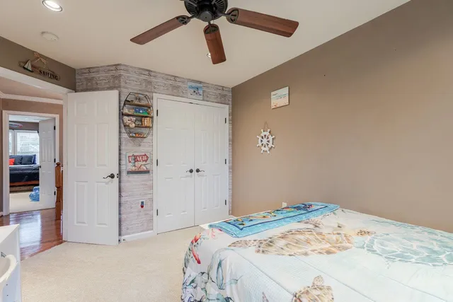 a bedroom with bed and mirror