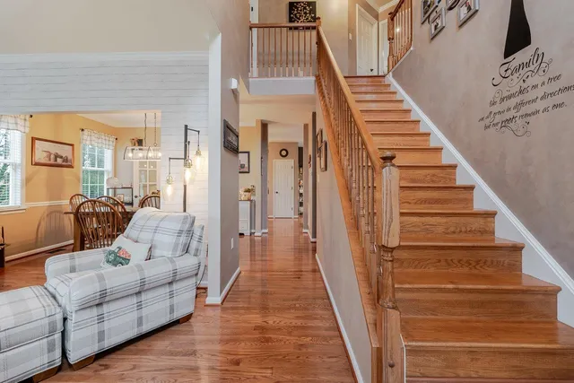 a view of a a dining room with furniture window and wooden floor