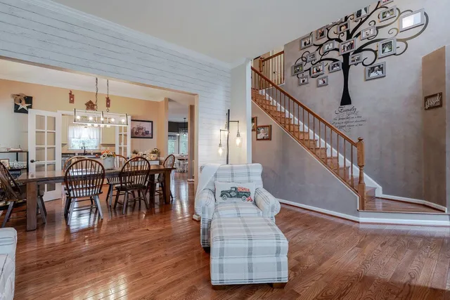 a kitchen with stainless steel appliances granite countertop a sink refrigerator and cabinets