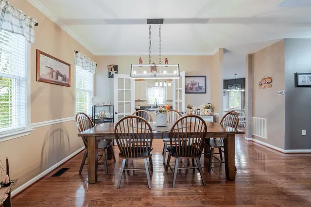 a kitchen with granite countertop a sink and white cabinets
