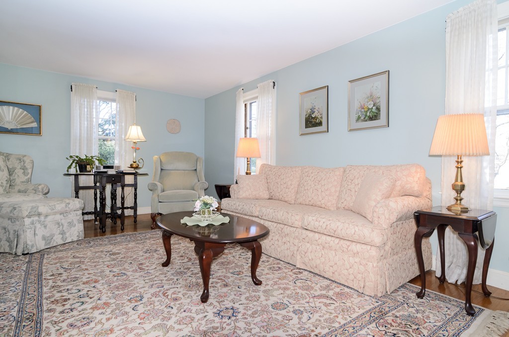22 MacArthur Road Wellesley, MA 02482 - Photo 3 of 15 a living room with furniture a lamp paintings and a window