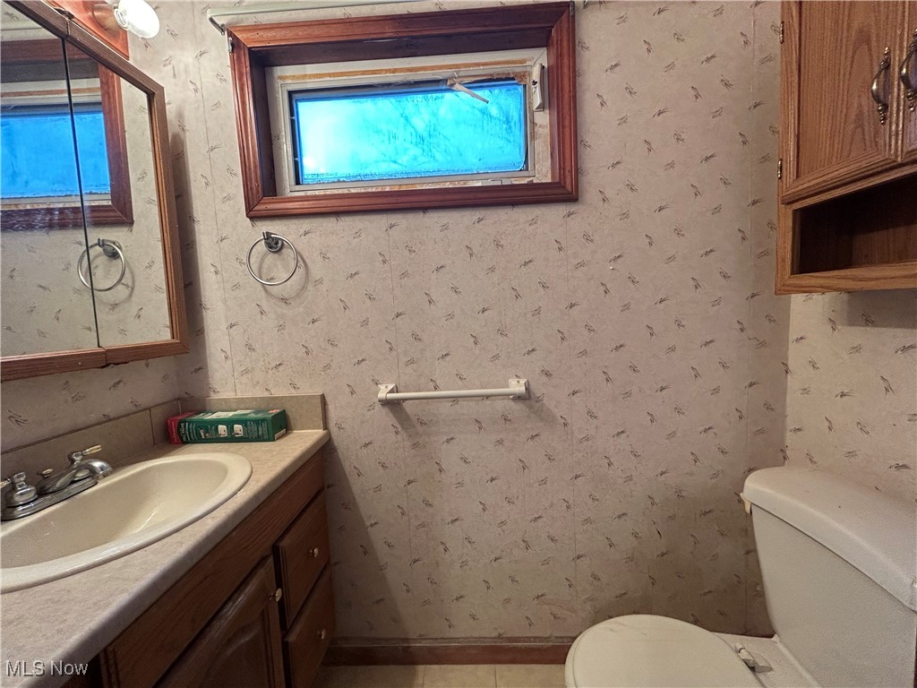 796 Rokeby Road Eastlake, OH 44095 - Photo 12 of 23 Bathroom with vanity, wallpapered walls, and light tile patterned floors
