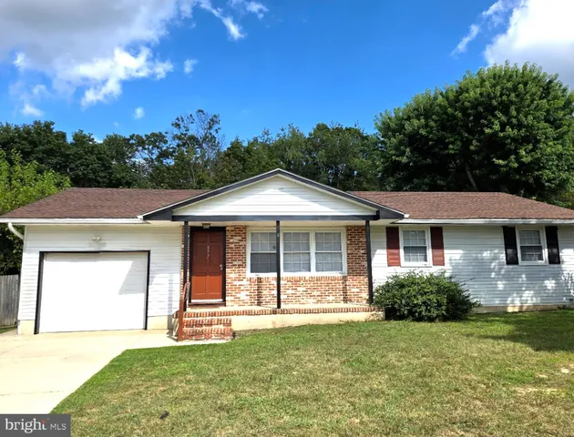 a front view of a house with a yard and porch