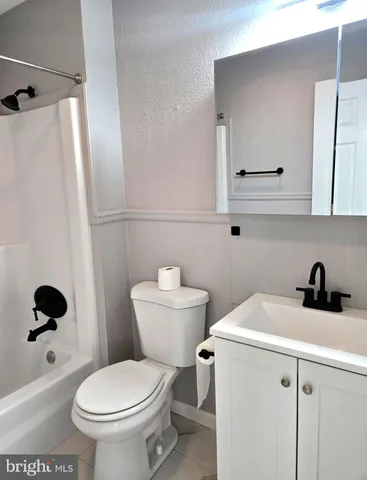a white toilet sitting next to a bathroom sink